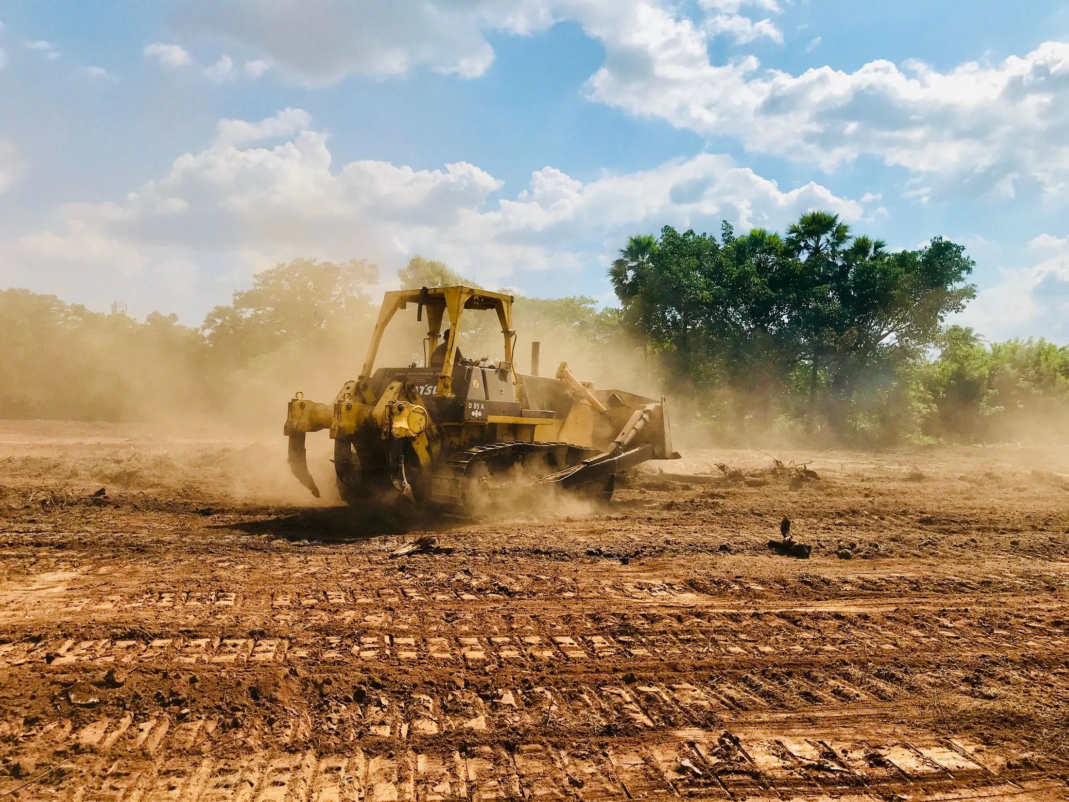 A dozer working a site in golden light